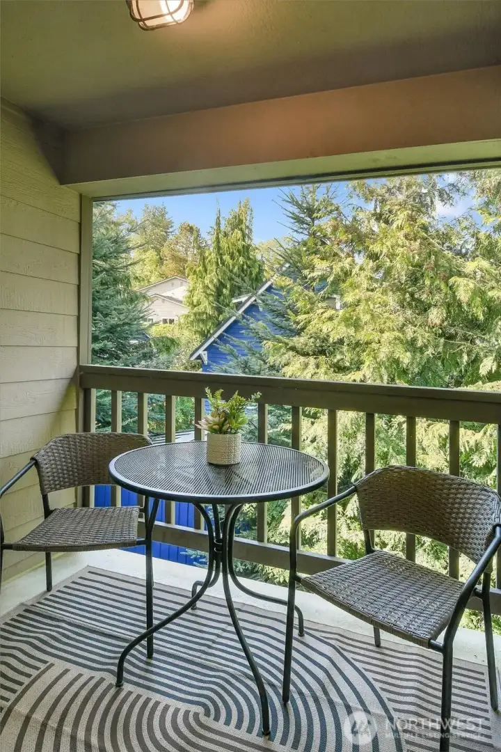 Private covered balcony offering tranquil greenery views—ideal for morning coffee or evening relaxation.