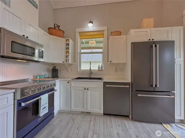 The recently renovated kitchen features luxury Viking appliances, Café refrigerator and dishwasher, Ruvati granite drop-in sink, and elegant marble countertops. The recently renovated kitchen features luxury Viking appliances, Café refrigerator and dishwasher, Ruvati granite drop-in sink, and elegant marble countertops.