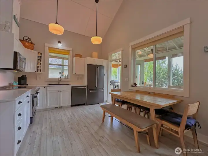With the kitchen opened directly to the indoor and outdoor dining areas, it’s easy to stay engaged in conversation while cooking and hosting. With the kitchen opened directly to the indoor and outdoor dining areas, it’s easy to stay engaged in conversation while cooking and hosting.