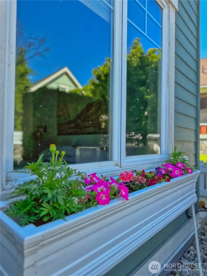 Flower-filled window boxes bring a cheerful, storybook touch to the cottage exterior. Flower-filled window boxes bring a cheerful, storybook touch to the cottage exterior.