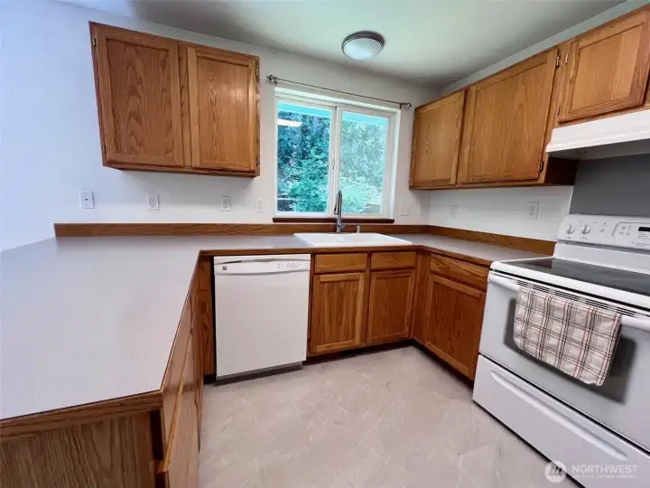 Nice views out the kitchen window, plenty of countertop work space and new flooring are features of this kitchen.