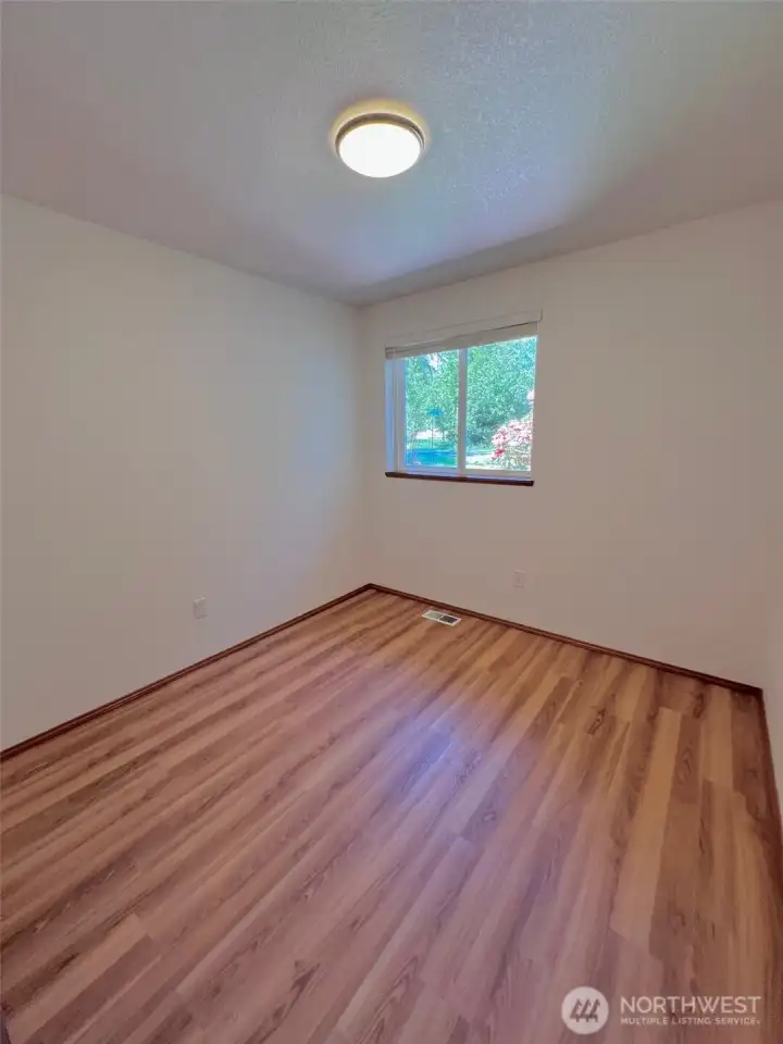 2nd of three bedrooms, all with vinyl plank flooring