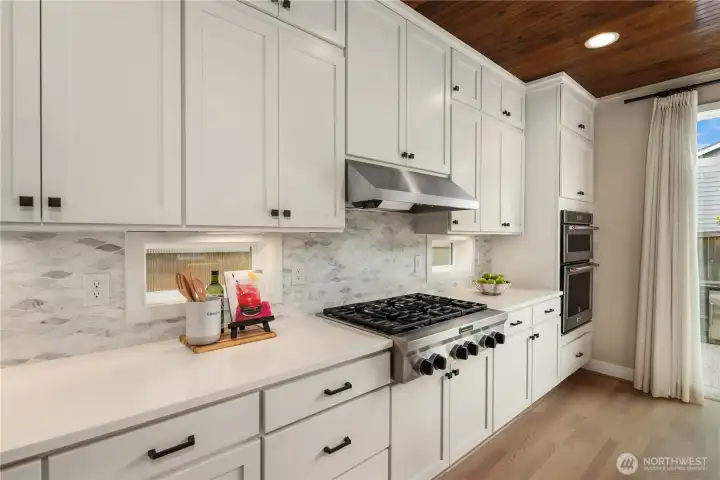 High style marble backsplash that compliments the quartz countertops and stainless steel appliances. High style marble backsplash that compliments the quartz countertops and stainless steel appliances.