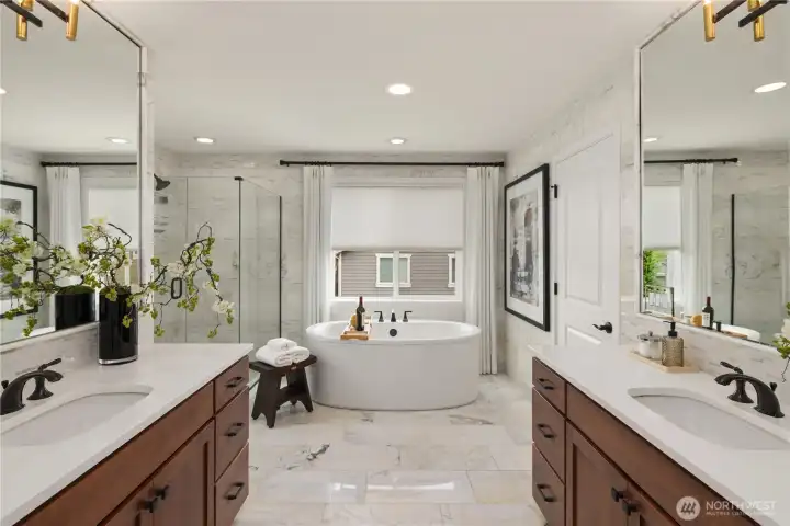 Primary spa inspired bath with freestanding bathtub, dual vanities, marble accents and custom drapes. Primary spa inspired bath with freestanding bathtub, dual vanities, marble accents and custom drapes.