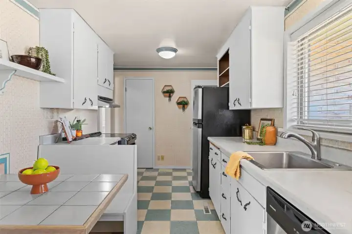 An efficient galley kitchen with abundant storage, including a generous pantry closet. An efficient galley kitchen with abundant storage, including a generous pantry closet.