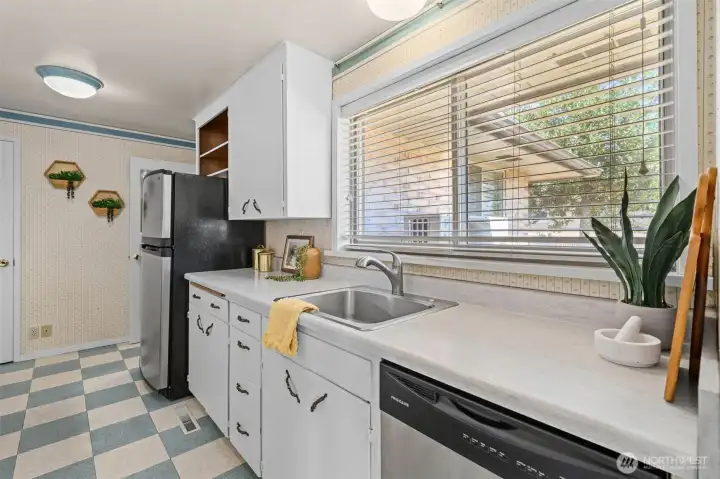 The kitchen window fills the workspace with natural light while allowing views of the side yard and park. The kitchen window fills the workspace with natural light while allowing views of the side yard and park.