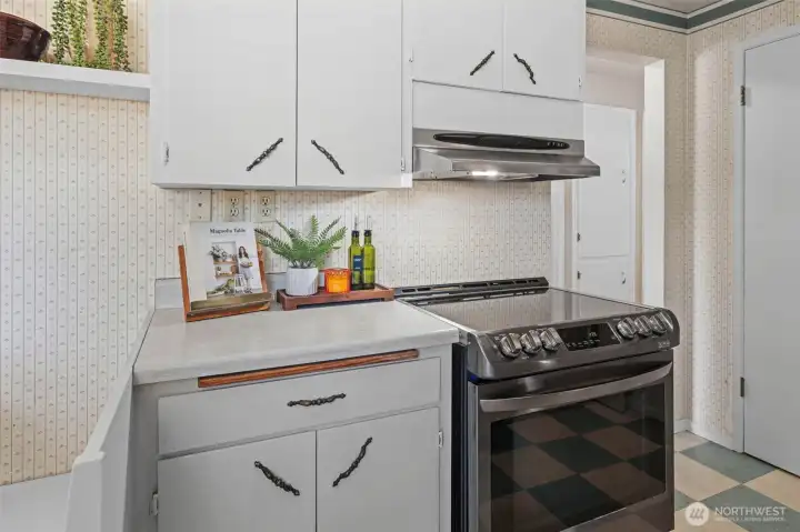 A newer range with a striking blue interior adds style to everyday cooking. Built-in hallway storage is another thoughtful mid-century touch. A newer range with a striking blue interior adds style to everyday cooking. Built-in hallway storage is another thoughtful mid-century touch.