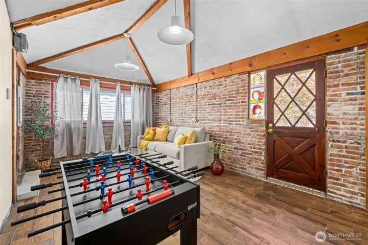 A versatile flex space with heated tile floors, private exterior access, and unique stained-glass windows offers endless possibilities. A versatile flex space with heated tile floors, private exterior access, and unique stained-glass windows offers endless possibilities.