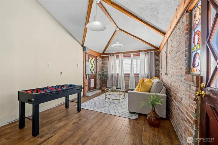 Vaulted beamed ceilings and a second exterior door create a bright, open, flexible space. Vaulted beamed ceilings and a second exterior door create a bright, open, flexible space.