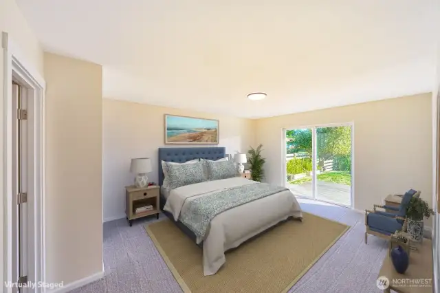 Primary bedroom with slider to back deck and lake view