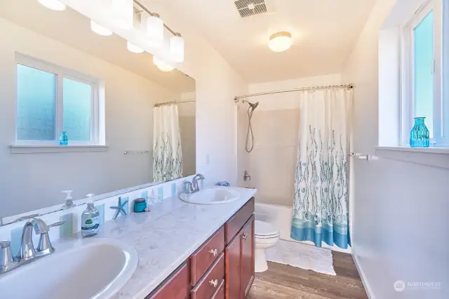 Primary bathroom with double sinks and tub