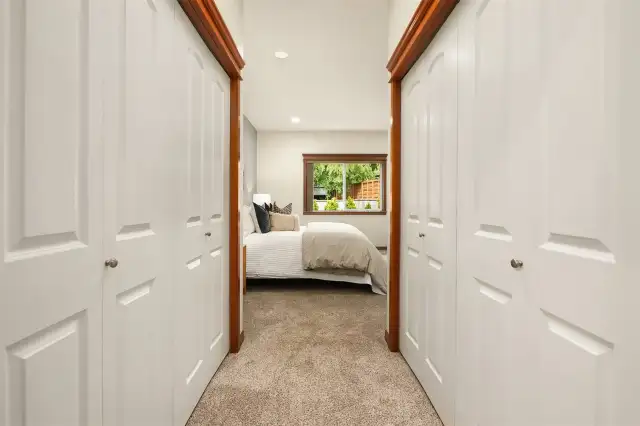 Primary double closets between bedroom and attached bathroom.