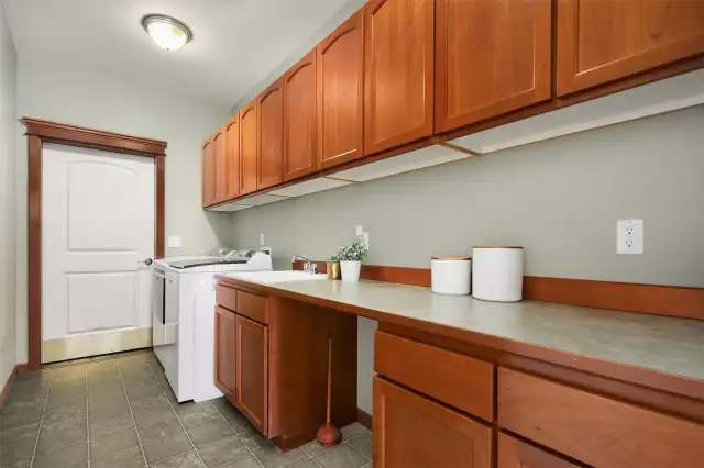 Massive laundry room with utility sink and storage.