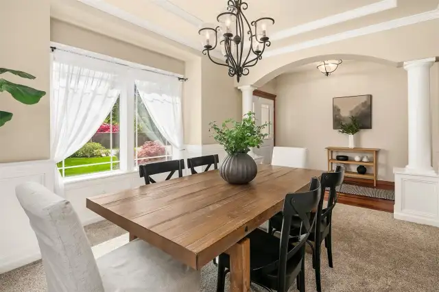 Notice column details and loads of light in the formal dining room.