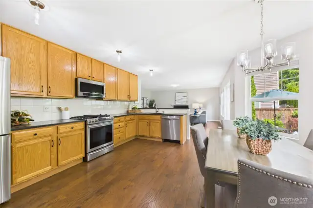 Enjoy seamless flow from the kitchen to the nook area, with stunning backyard views through walls of windows. Perfect for everyday meals and entertaining, this space is filled with light and warmth.
