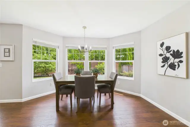 Surrounded by oversized windows, this sun-drenched breakfast nook offers a tranquil space to sip morning coffee or host casual meals. Overlooking a beautifully landscaped yard, it’s a picture-perfect corner of the home.
