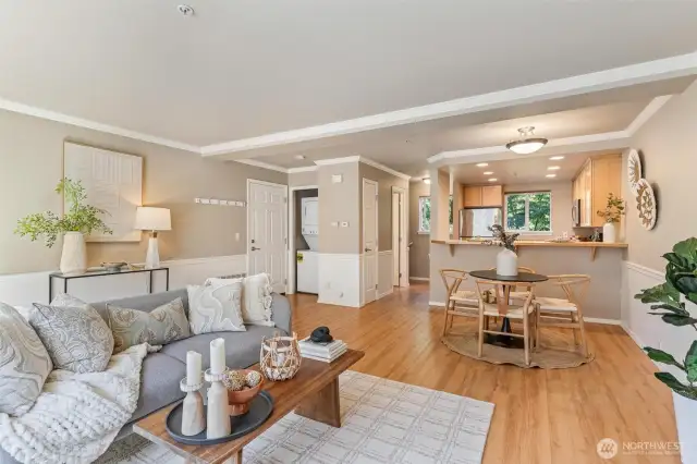 Bright and airy living room with oversized windows, sleek vinyl plank flooring.