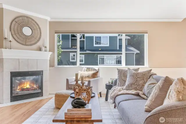 Light-filled living room with vaulted ceilings and a cozy fireplace.
