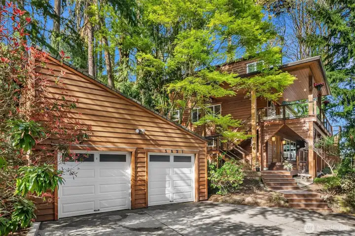 Welcome to 5021 E. Mercer. The wide driveway offers a two car detached garage with extended loft storage.