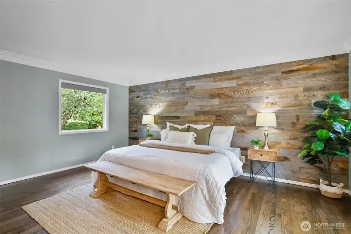 MAIN FLOOR primary ensuite with custom barnwood wall.