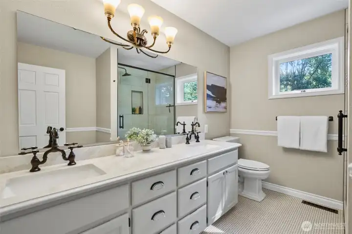 Remodeled guest bathroom with full size tiled, walk-in shower.