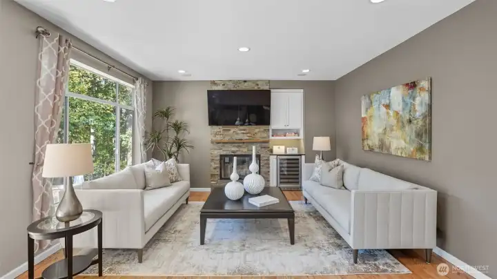 A spacious Family room boasts wood burning fireplace with slate surround and mantle.  The is a perfect spot for a large screen TV and it has a built-in beverage cooler.