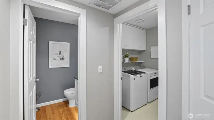 Shows the utility room and the powder room proximate then the location of the 2 car garage through the utility room.
