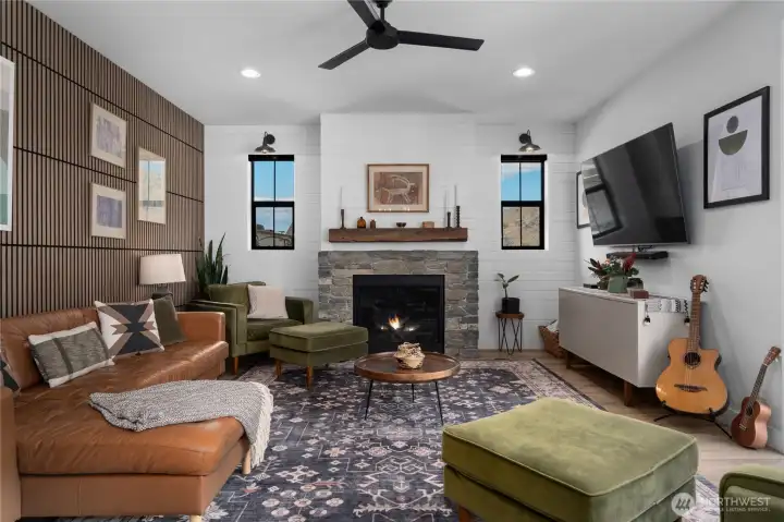 Propane fireplace with stone from Montana surround it with shiplap above. Real rustic beam mantle adds charm to this space.