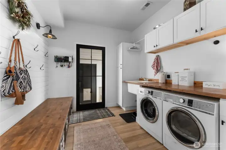 Large mudroom/laundry room just off the kitchen.