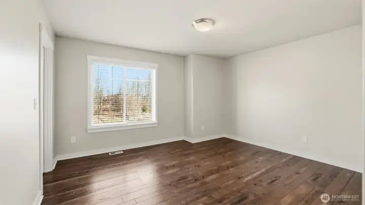 Spacious 4th bedroom on upper level offers large walk-in closet.