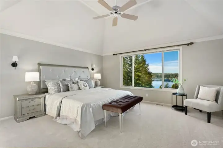 Luxurious primary suite with vaulted ceilings and breathtaking lake views - a private retreat.