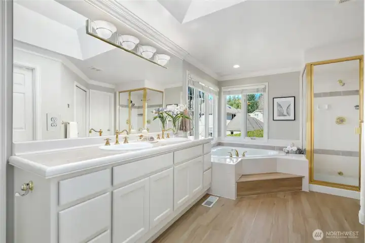 Spa-inspired primary en-suite featuring dual vanities, soaking tub, separate shower, and abundant natural light. Featuring second walk in closet.