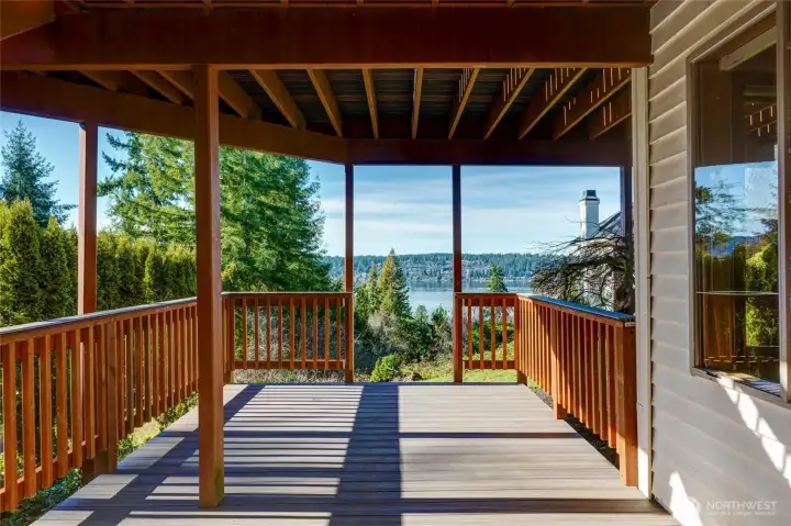 Private covered new deck off the lower-level bonus room, offering tranquil territorial and water views — perfect for year-round outdoor living.