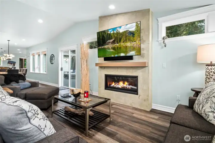 Cozy gas fireplace feature wall anchors the living room, creating a warm and welcoming space for relaxing evenings.