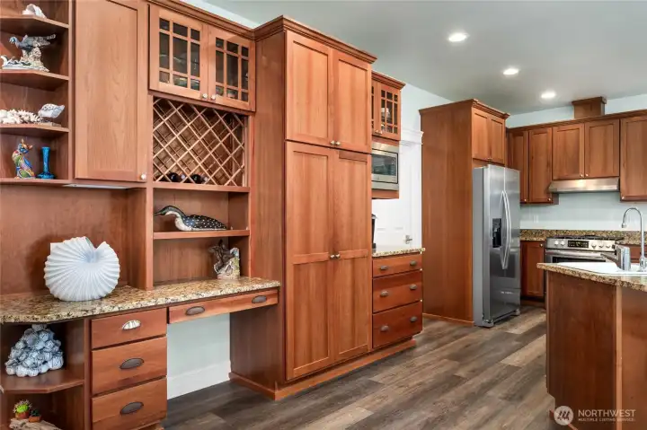 Custom cherry cabinetry with built-in storage, wine rack, and display shelving, blending beauty and functionality.