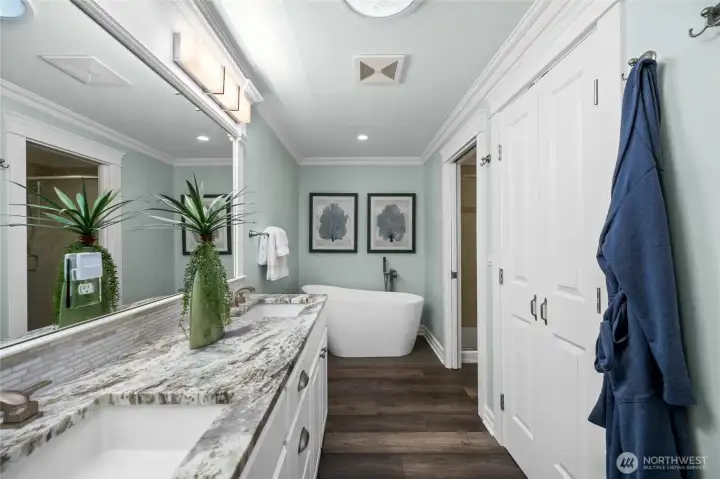 Spa-like primary bath featuring a freestanding soaking tub and private walk-in shower.