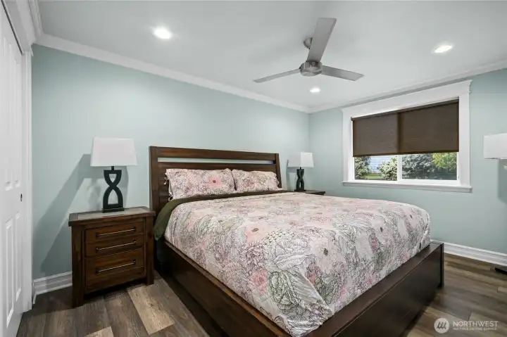 Bright and comfortable secondary bedroom with ceiling fan, large window, and ample closet space.