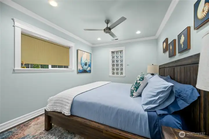 Well-proportioned guest bedroom with soft natural light and neutral finishes ready for guests or family.