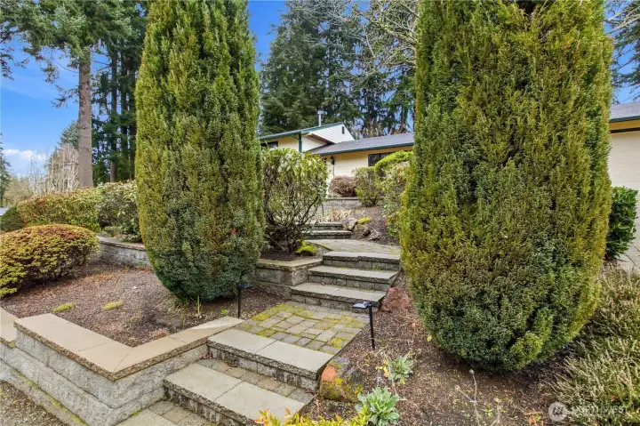 Mature, thoughtfully designed landscaping creates a warm and welcoming approach to the home while offering privacy and a tranquil neighborhood setting.