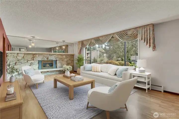 Light-filled living room features expansive picture windows that frame peaceful views of the surrounding greenery. **VIRTUALLY STAGED**