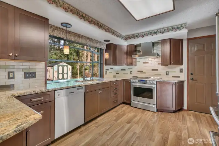 Beautiful granite countertops and warm wood cabinetry create a timeless and inviting cooking space.