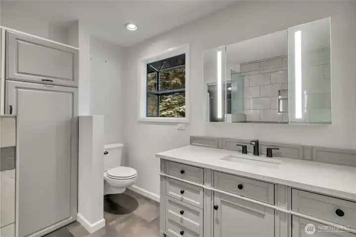 Updated vanity and modern finishes create a bright and functional main bathroom space. And yes---another garden window!