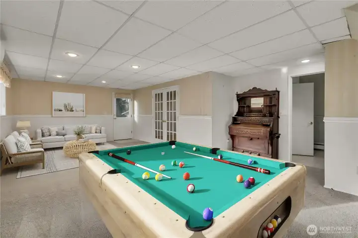 Large recreation room provides endless possibilities—perfect for a game room, media space, entertaining guests or possible ADU. The exit door to the outside and additional 4th bedroom to the right (was used as a den) and adjacent remodeled 3/4 bathroom would make a perfect set-up! **VIRTUALLY STAGED**