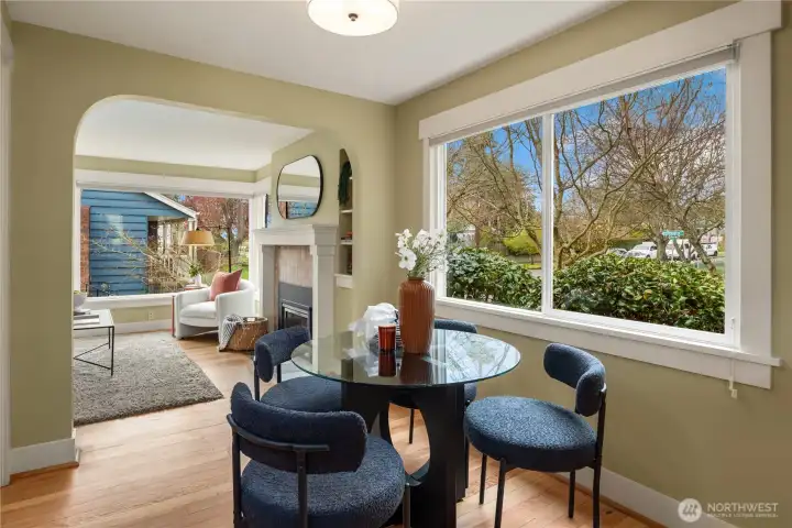 The dining room looks out over the beautifully landscaped front yar through the oversized window.