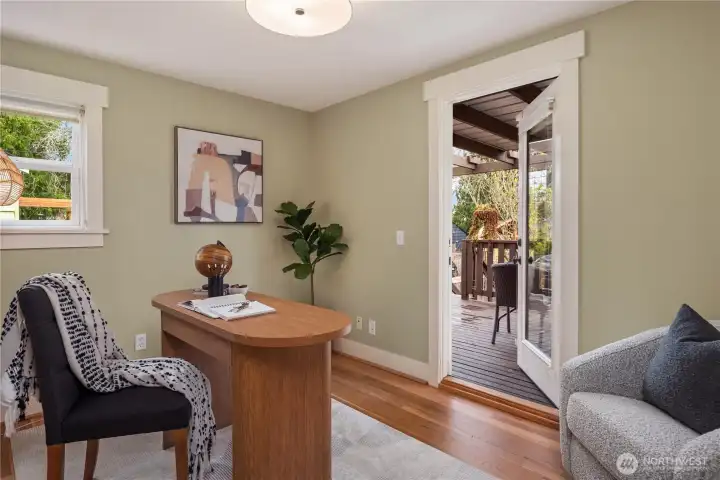 The second bedroom on the main level features a french door that leads to the back deck. Another door off the kitchen also takes you to the back deck and backyard.