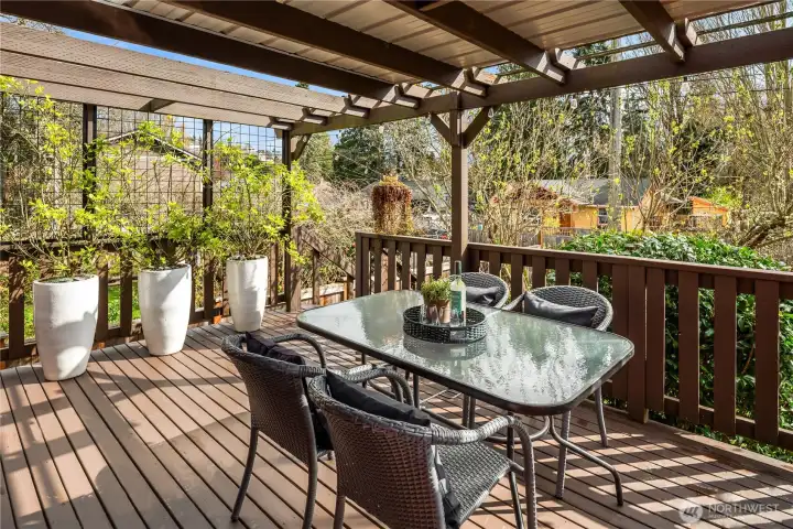 The deck wraps around to the side door off the kitchen and has stairs down to the backyard.