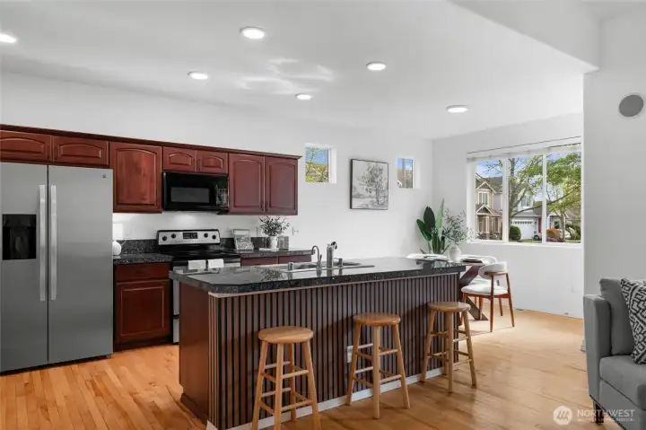 THE ISLAND | Newly refaced with beautiful paneling, this island does double duty acting as another area for seating and eating.