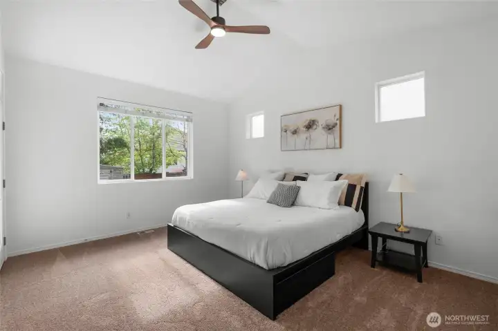 MAIN FLOOR PRIMARY SUITE | You'll love this spacious room with tall ceiling and a beautiful ceiling fan to keep you cool on warm evenings. Don't miss the brand NEW carpet.