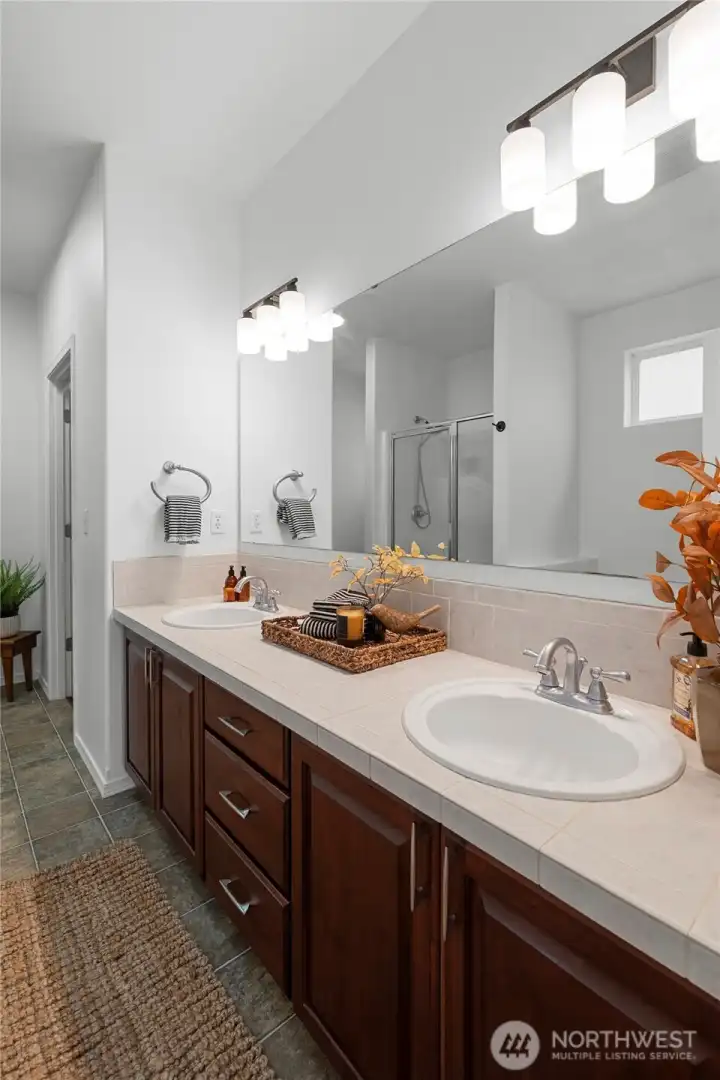 PRIMARY EN-SUITE BATHROOM | Enjoy this spacious bathroom with separate tub and shower. The door at the back on the right leads to the walk-in closet.