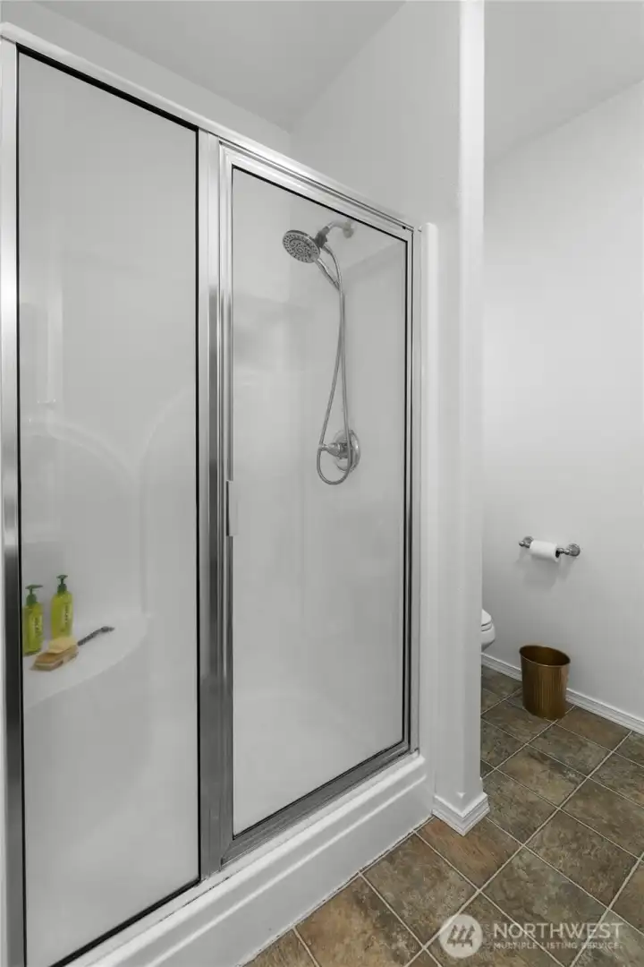 PRIMARY EN-SUITE SHOWER | This bathroom features a separate shower and tub.